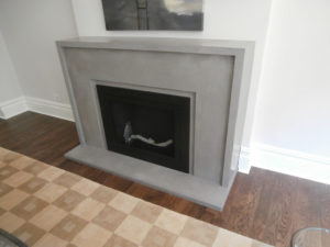 a concrete fireplace surround wiht a traditional design