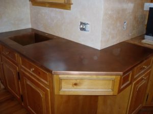 corner style copper countertop with an integral copper sink, patina finish copper