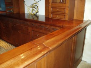 hinged door on a classic pub wood bar top in wide plank cherry
