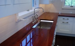 High Polish Cherry Wood Countertop in a White Kitchen