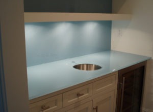 backpainted glass wall panels to match countertop