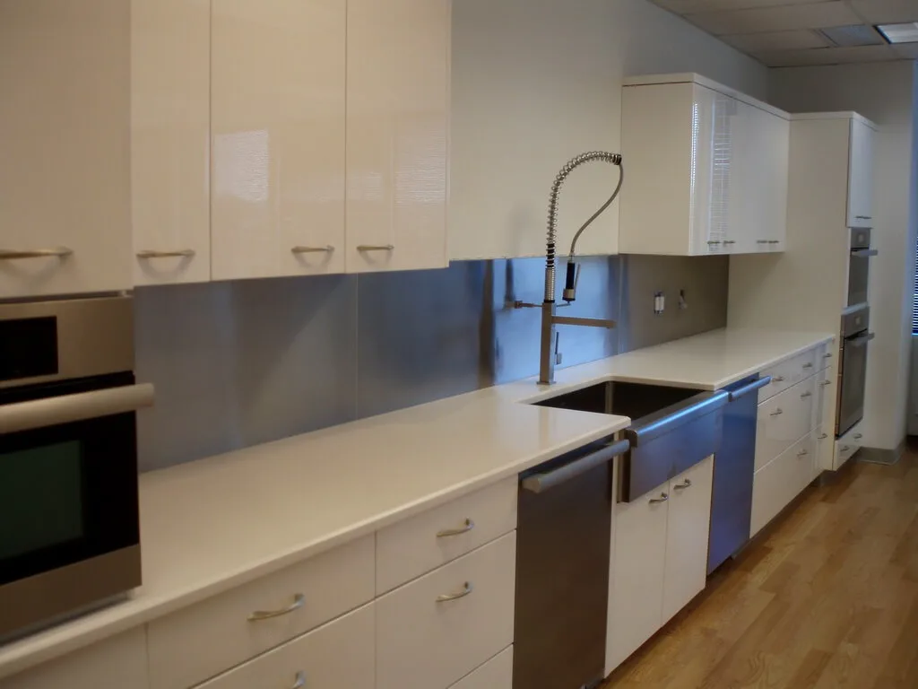 This stainless steel backsplash goes well with the stainless steel farm sink.